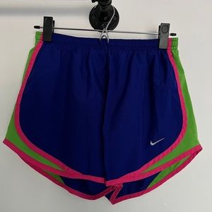 Nike purple and neon green and pink athletic shorts.